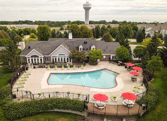 A large building with a pool in front of it at Towne Lakes Apartments, Grand Chute