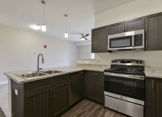 Kitchen with Breakfast Bar at Dodson Pointe Apartment Homes, Rogers, AR, 72758