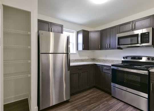 Kitchen with Window and Large Pantry at Dodson Pointe Apartment Homes, Rogers, AR, 72758