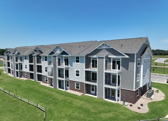 an aerial view of an apartment building with green grass at Dodson Pointe Apartment Homes, Rogers, AR, 72758