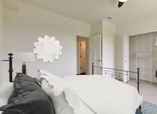 A bedroom with a bed and a walk in closet at Dodson Pointe Apartment Homes, Rogers