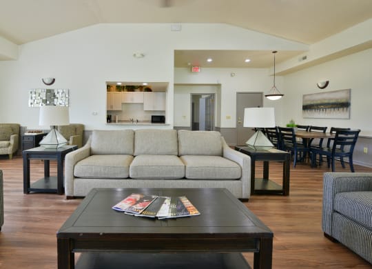 a living room with a couch and a coffee table at Heatherwood Apartments, Grand Blanc