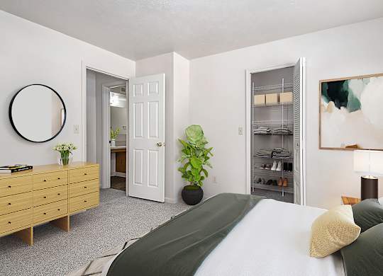 A bedroom with a bed, dresser, and a walk-in closet at Dupont Lakes Apartments, Fort Wayne