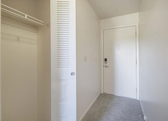 A entryway with a white closet at Dupont Lakes Apartments, Fort Wayne