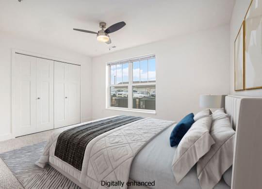 Bedroom with large closet and ceiling fan at Eagle Ridge Apartment Homes,  Michigan