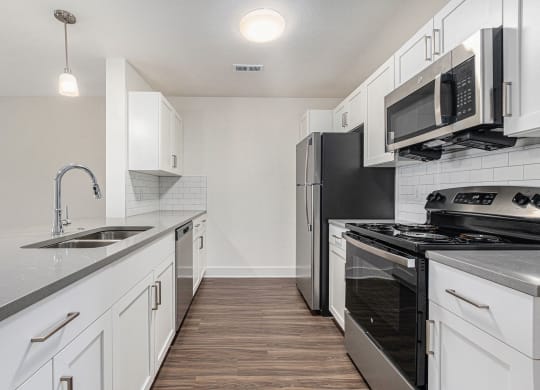 Two bedroom kitchen with shaker style white cabinets at Eagle Ridge Apartment Homes, Traverse City, Michigan