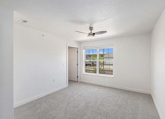 Spacious bedroom with large windows and walk in closet at Eagle Ridge Apartment Homes,  Michigan 49685