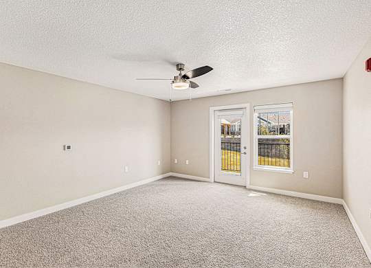 Two bedroom living room with ceiling fan at Eagle Ridge Apartment Homes, Traverse City