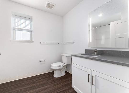 A bathroom with a window and hard surface flooring at Eagle Ridge Apartment Homes, Traverse City, MI 49685