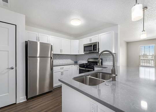 Kitchen with white shaker style cabinets and stainless steel appliances  at Eagle Ridge Apartment Homes, Traverse City, Michigan