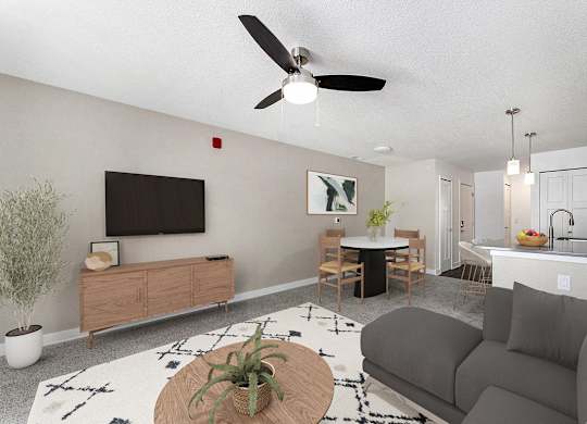 A living room with a grey couch, a ceiling fan, and a wooden coffee table at Eagle Ridge Apartment Homes, Traverse City, MI 49685