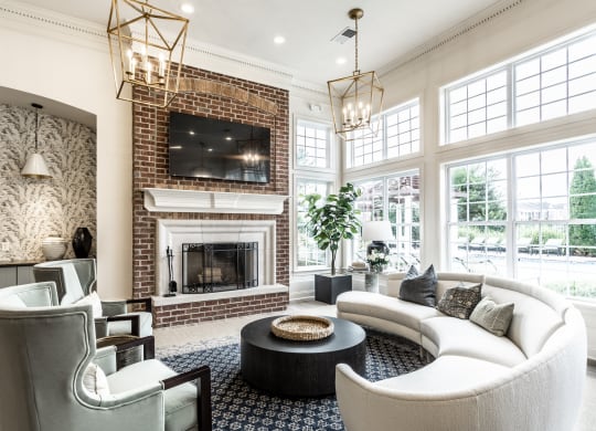 a couch and fireplace in the clubhouse  at Alexandria of Carmel Apartments, Carmel