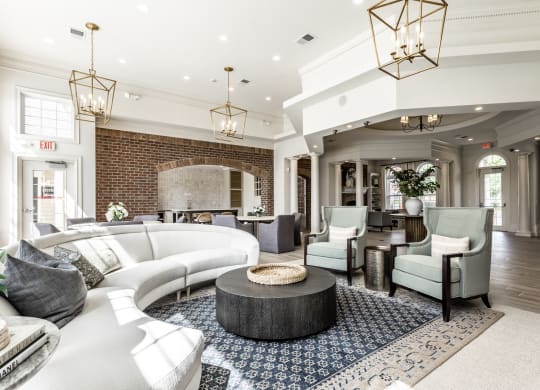 Couch chairs and chandeliers in clubhouse at Alexandria of Carmel Apartments, Carmel, IN