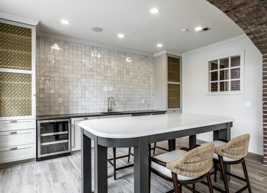 Kitchenette with island and tile backsplash at Alexandria of Carmel Apartments, Carmel