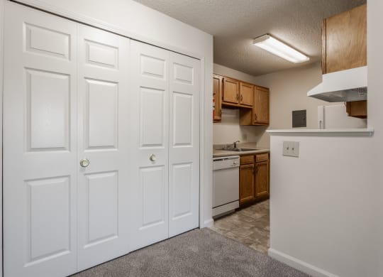 a kitchen with white doors and brown cabinets at Bavarian Village Apartments, Indiana