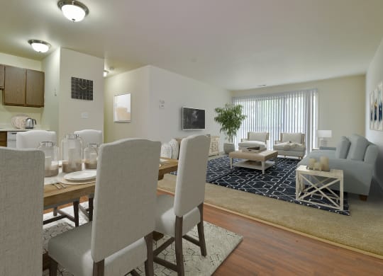 a living room and dining room with a table and chairs at Grand Bend Club Apartments, Grand Blanc, MI