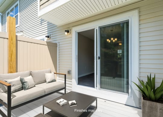 a patio with a couch and a sliding glass door  at Killian Lakes Apartments and Townhomes, Columbia, SC, 29203