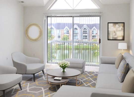 a living room with couches and chairs and a large window at LakePointe Apartments, Batavia, OH, 45103