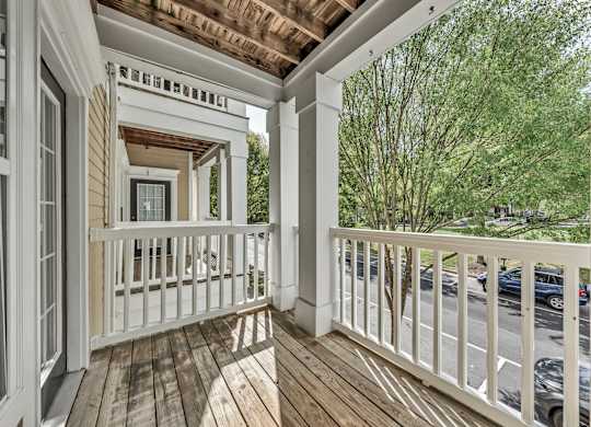 a covered porch with wood floors and white railings at Enclave Apartments, Midlothian, VA, 23114