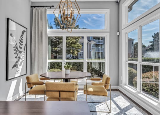 a dining room with large windows and a table and chairs at Trophy Club at Bellgrade, Midlothian, VA, 23113