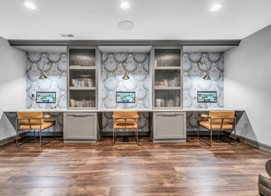 an office space with two desks and chairs and a counter with two computers at Trophy Club at Bellgrade, Midlothian, VA, 23113