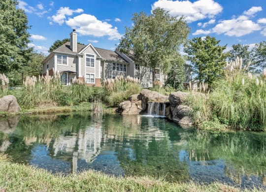 a pond with a house in the background at Trophy Club at Bellgrade, Midlothian, VA, 23113