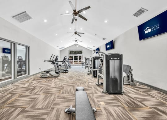 a gym with cardio machines and a ceiling fan at Trophy Club at Bellgrade, Midlothian, VA, 23113