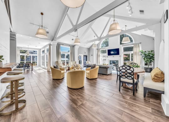 a large living room with chairs and tables and a large windows at Trophy Club at Bellgrade, Midlothian, VA, 23113