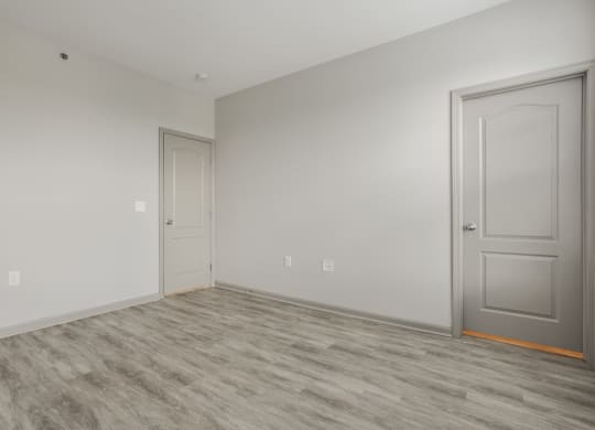 an empty room with a door and a white wall at The Avenue at Polaris Apartments, Columbus, OH