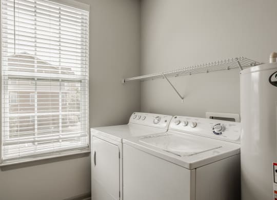 a white washer and dryer in a room with a window and a white at The Avenue at Polaris Apartments, Columbus, OH