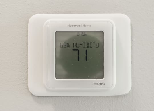 a white thermostat on a wall with an 11 on it at The Avenue at Polaris Apartments, Columbus, OH