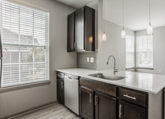 an empty kitchen with a sink and a window at The Avenue at Polaris Apartments, Columbus, OH