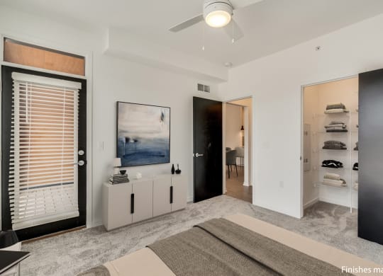 a bedroom with a bed and a ceiling fan  at Uptown Square Apartments, Michigan, 48083