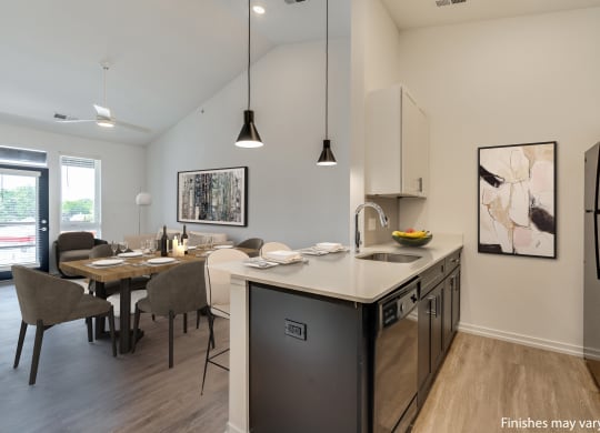 a kitchen and dining area in a 555 waverly unit  at Uptown Square Apartments, Troy, MI