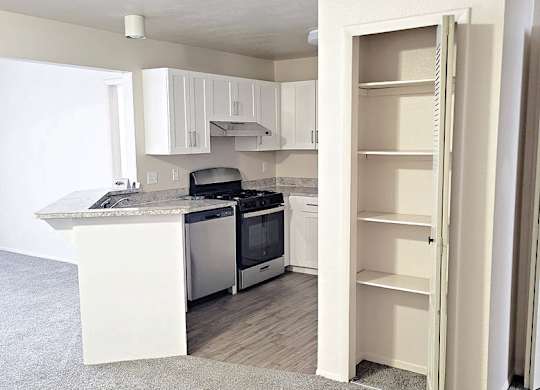 Upgraded kitchen with white cabinets at Emerald Park Apartments in Michigan 49001