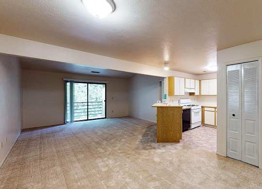 A dining and living room with access to a balcony at Emerald Park Apartments, Michigan