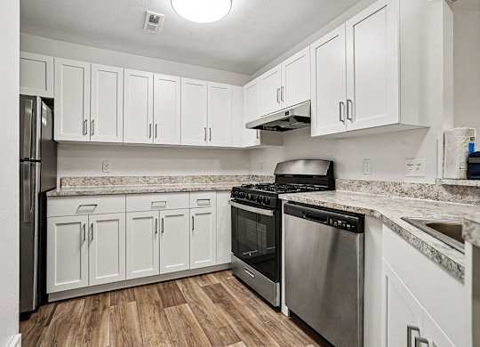A kitchen with white cabinets and stainless steel appliances at Emerald Park Apartments, Kalamazoo, Michigan