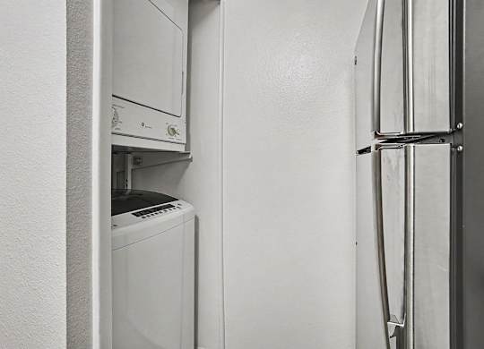 A washer and dryer in a kitchen at Emerald Park Apartments, Kalamazoo, Michigan