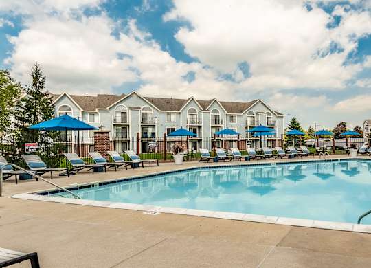 A large swimming pool in front of a resort