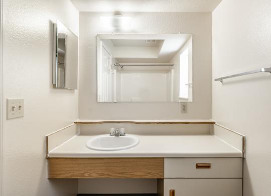A bathroom with a sink and mirror