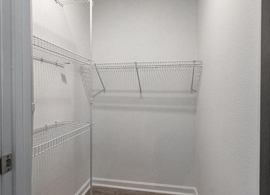 an empty walk in closet in a white room with white walls and a white door at Latitudes Apartments, Indianapolis, Indiana
