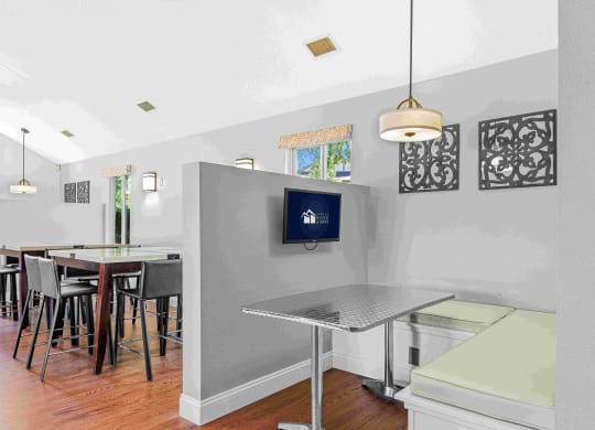 a kitchen and dining room with a bar and a table at Bay Pointe Apartments, Lafayette, IN, 47909