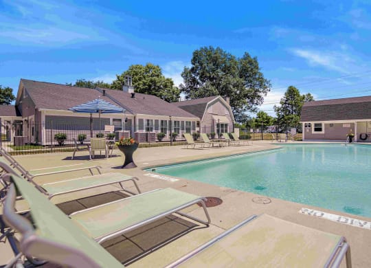 our apartments have a swimming pool with chairs and umbrellas at Bay Pointe Apartments, Lafayette, IN, 47909