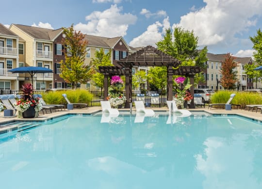 our apartments offer a swimming pool with a gazebo and umbrellas at The Avenue at Polaris Apartments, Columbus, OH