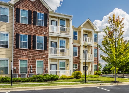 a row of apartment buildings on the corner of a street at The Avenue at Polaris Apartments, Columbus, OH