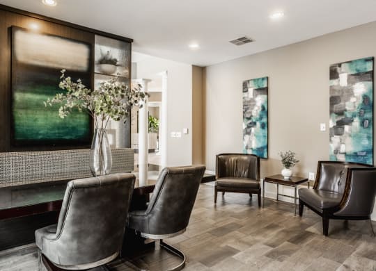 a living room with leather chairs and a fireplace at The Avenue at Polaris Apartments, Columbus, OH