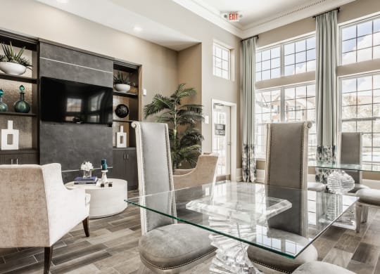a living room with a glass table and chairs at The Avenue at Polaris Apartments, Columbus, OH