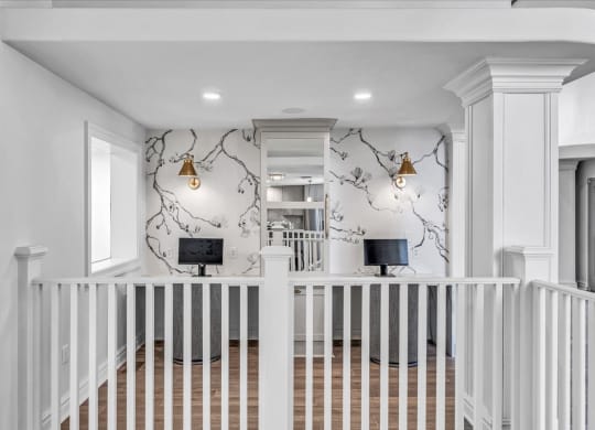 the entryway of a home with a white staircase and a wall with a wallpaper at The Vinings Apartments in Richmond, VA