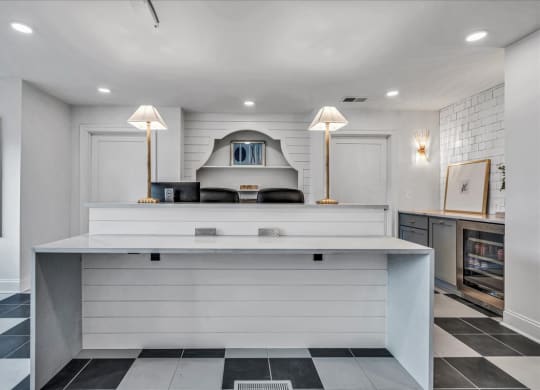 the kitchen has a large counter with two lamps at The Vinings Apartments in Richmond, VA