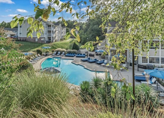 a swimming pool at the resort on a sunny day at The Vinings Apartments in Richmond, VA